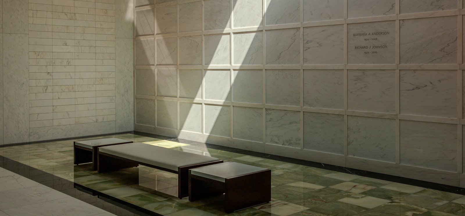Sunlit marble columbarium and memorial niches in a mausoleum interior